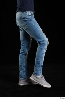 Claudio  1 blue jeans clothing flexing grey sneakers leg…